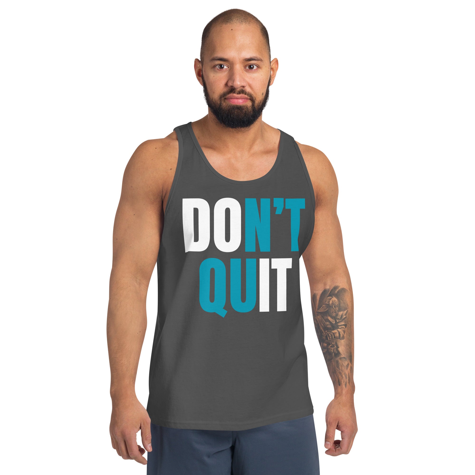 A man wearing a gray tank top with bold text "Don't Quit," delivering a motivational message perfect for fitness enthusiasts and athletes.