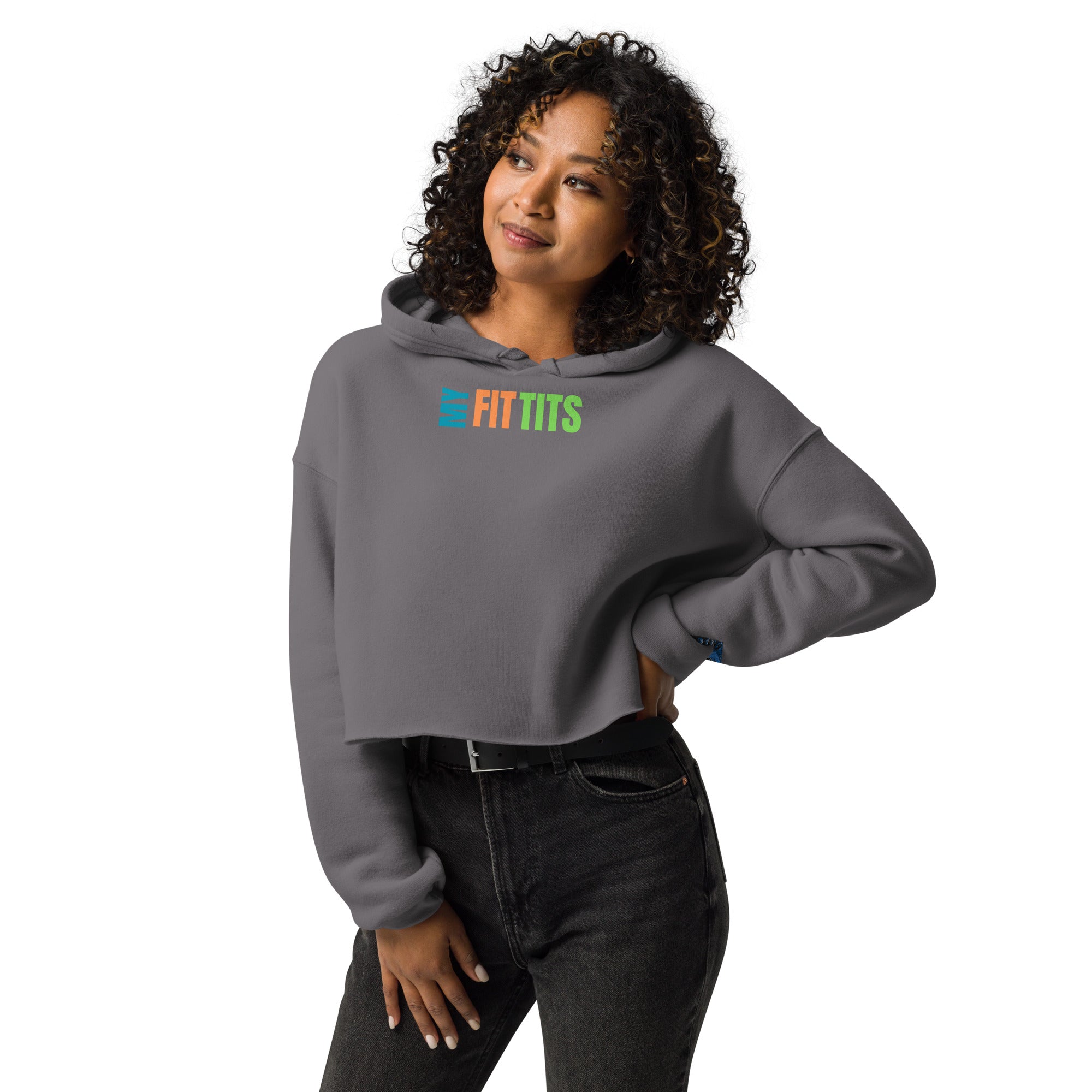 A woman wearing a gray cropped hoodie with the colorful "My Fit Tits" design, combining fitness style with comfort for active lifestyles.