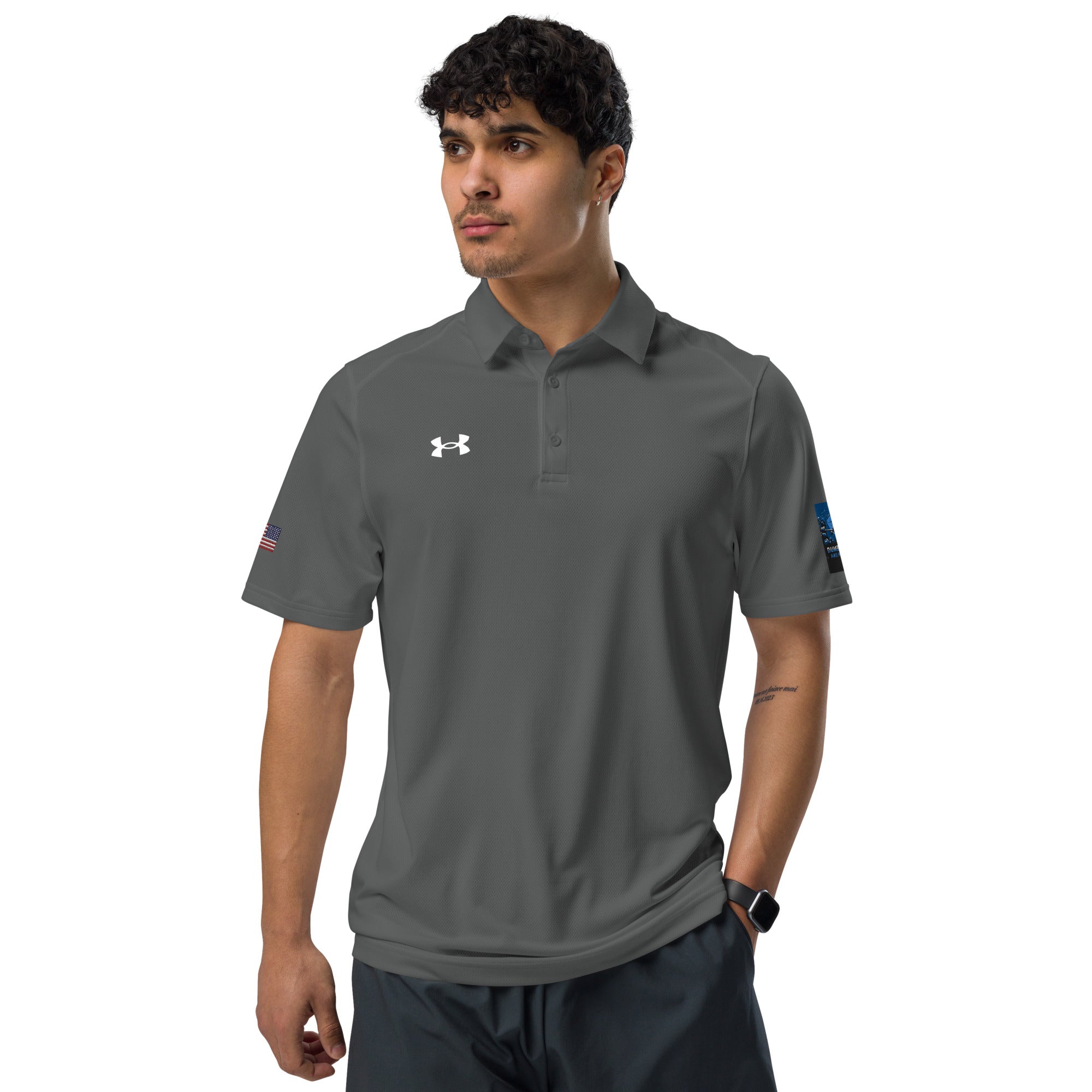 A man wearing a grey Under Armour polo shirt featuring the Dumbbells and Hotels logo, blending professional style with athletic performance.